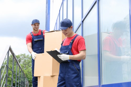Man with van removal team loading boxes in London street