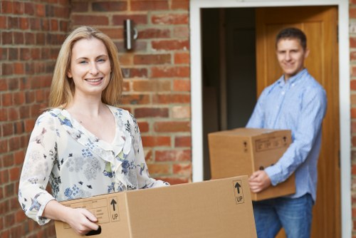 Removal team planning a London home move with boxes and furniture