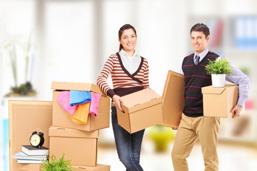 Professional movers handling furniture in a London flat