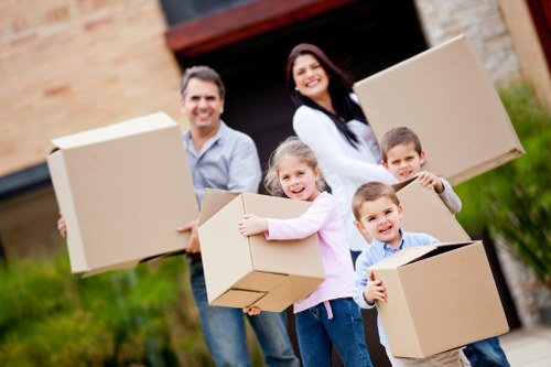 Professional movers handling furniture in a London property