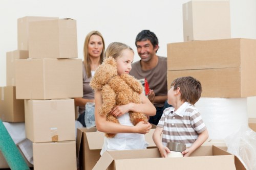 Removal team carrying furniture from a flat with stair and access challenges